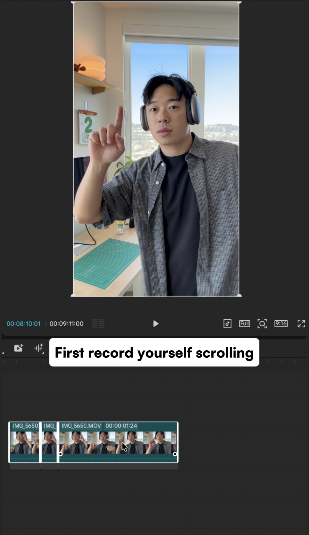 A vertical recording of a person wearing headphones and holding up a finger to scroll.